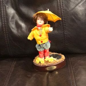 An original Marie Osmond doll with base and stand.